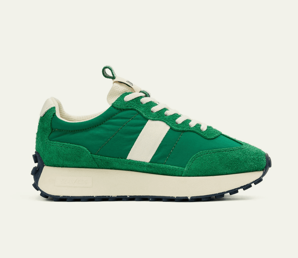 Green retro sneaker with white stripe and laces, off-white sole, and textured outsole.