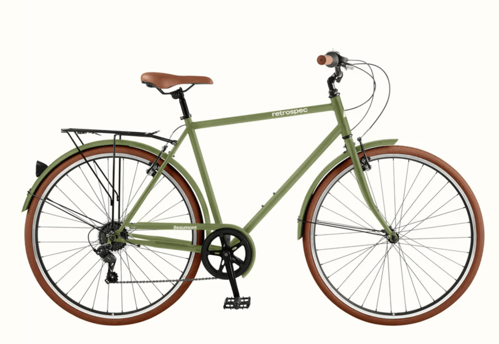 Green retro-style bicycle with brown tires and saddle on a white background.