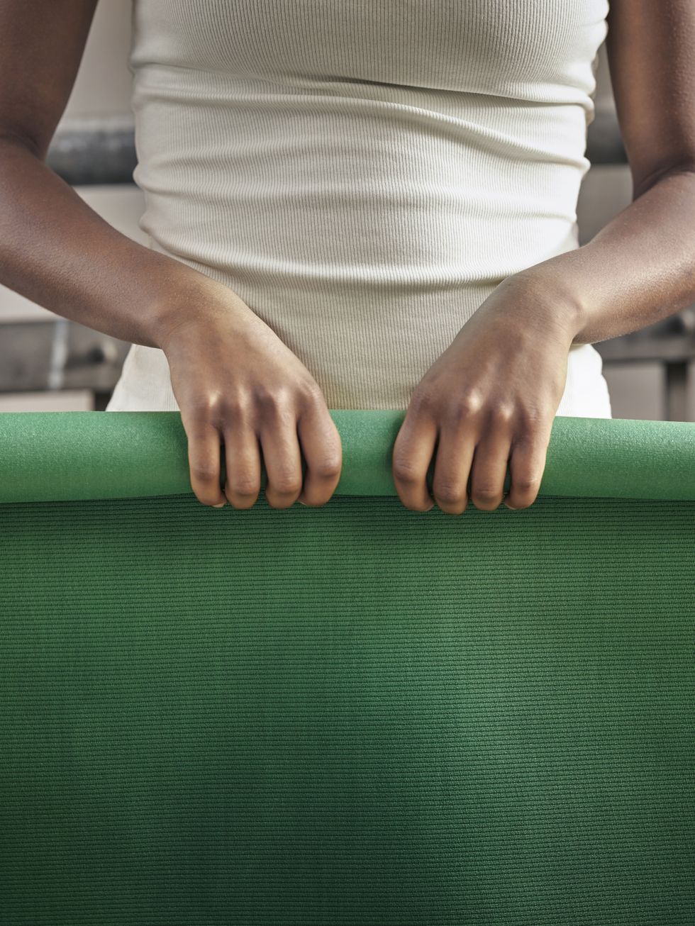 green yoga mat rolled up
