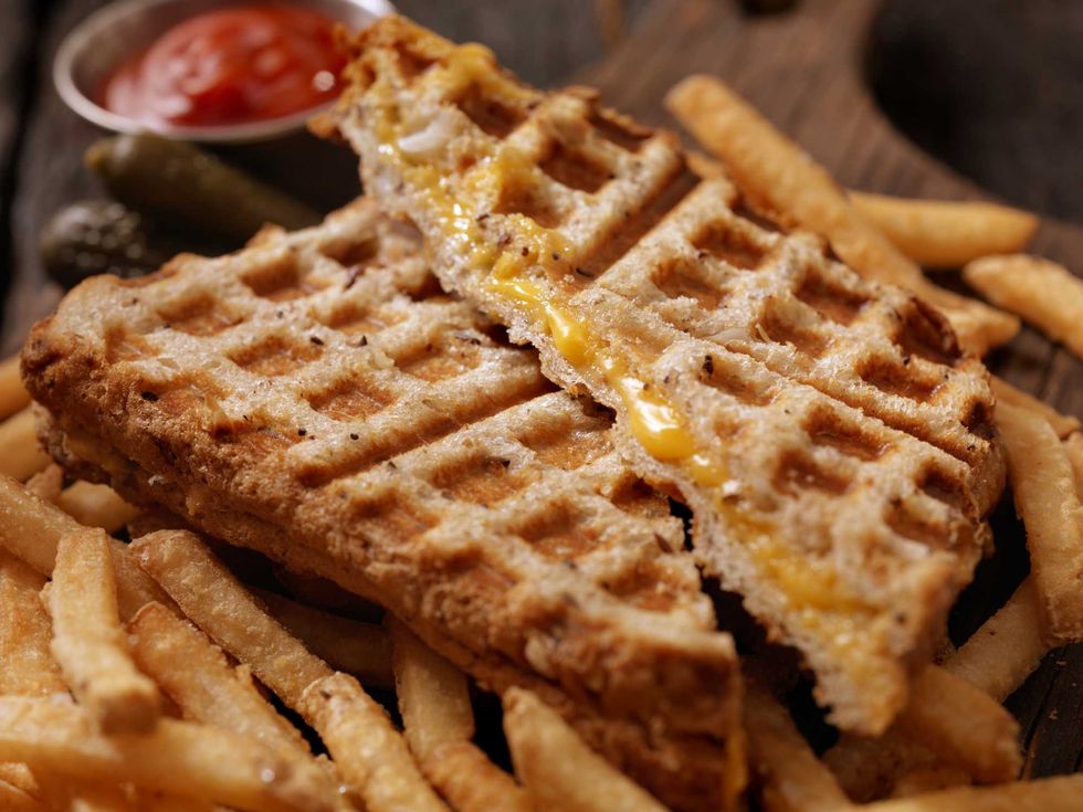 Grilled cheese sandwich with fries and a side of ketchup.