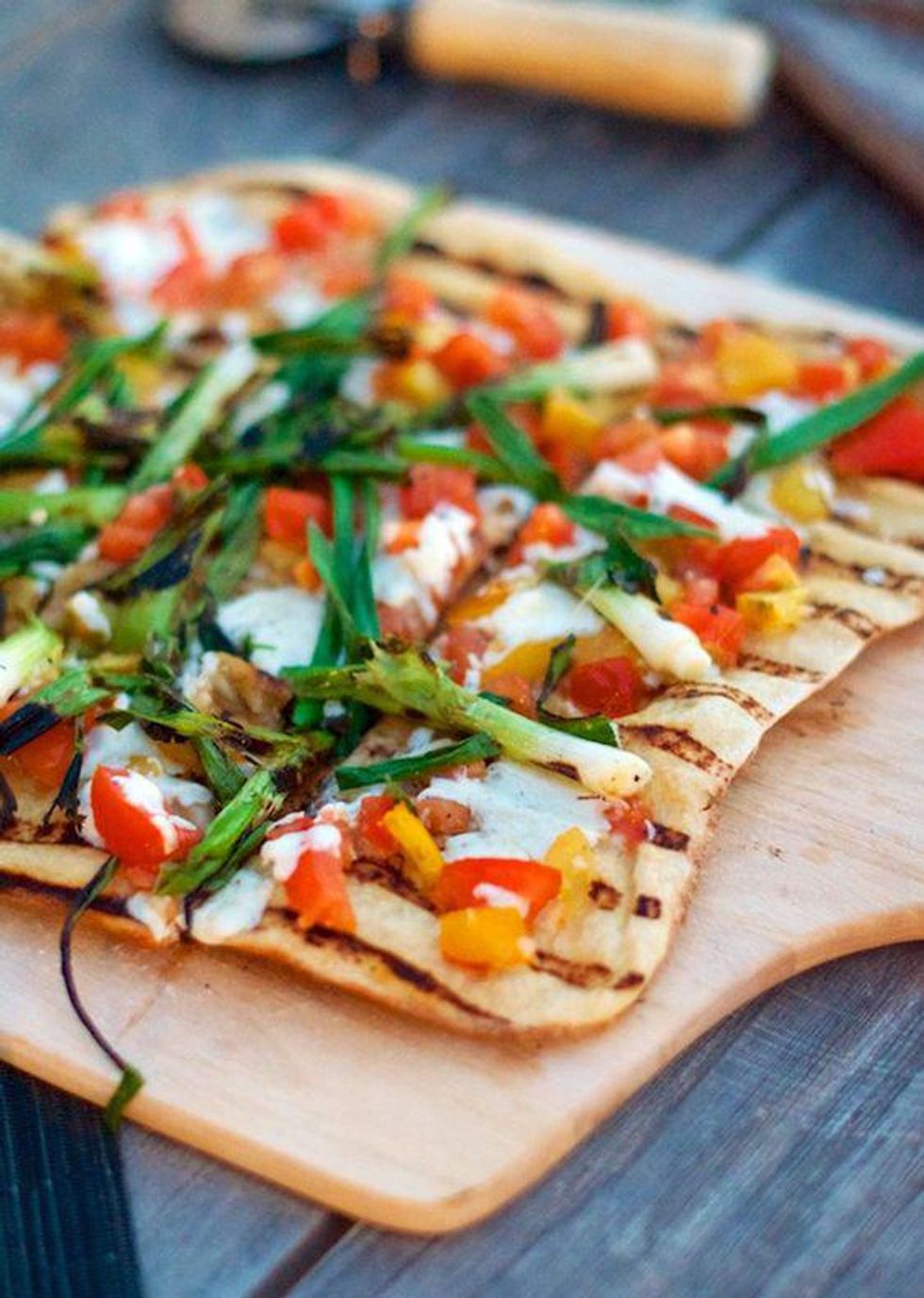 Grilled Heirloom Tomato Checca Pizza on a cutting board