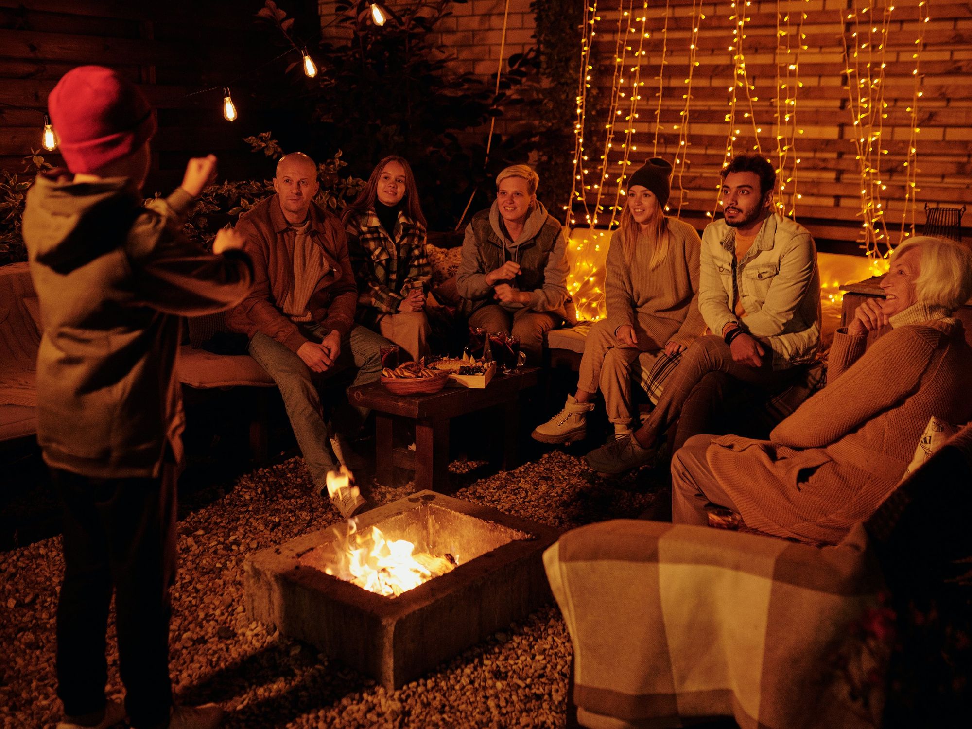 group of friends around a fire pit