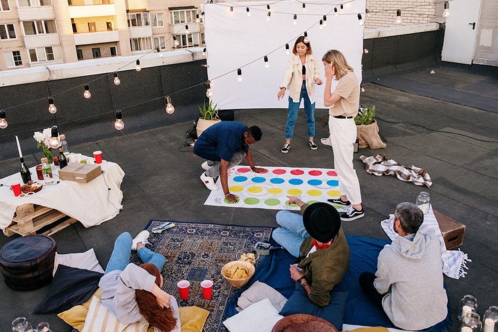 group of friends playing games on a rooftop