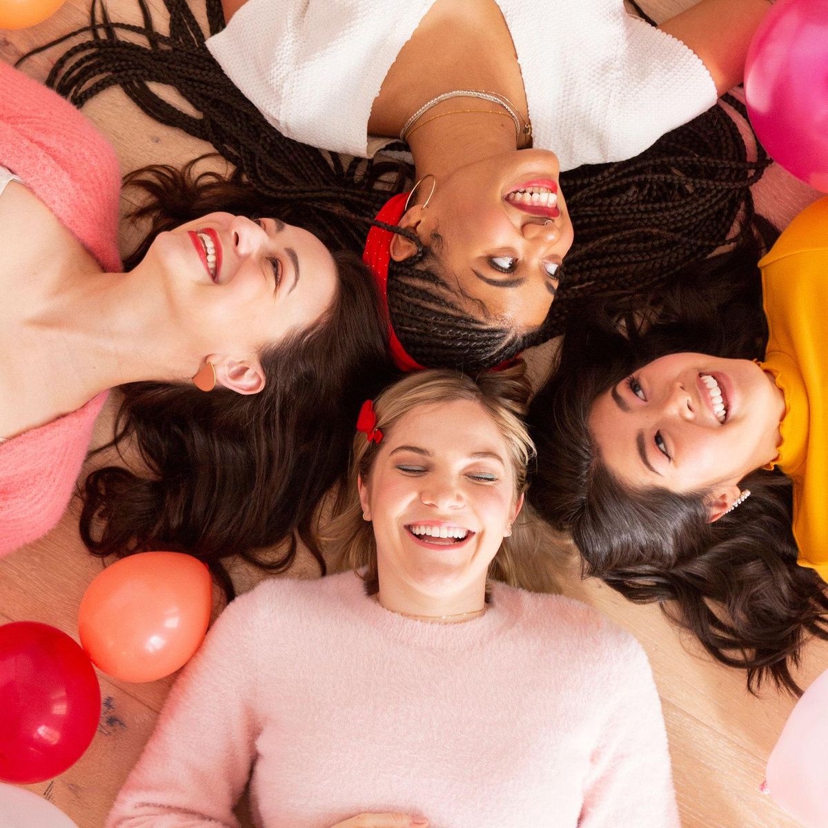 group of girlfriends surrounded by balloons how to celebrate with someone who doesn't want gifts