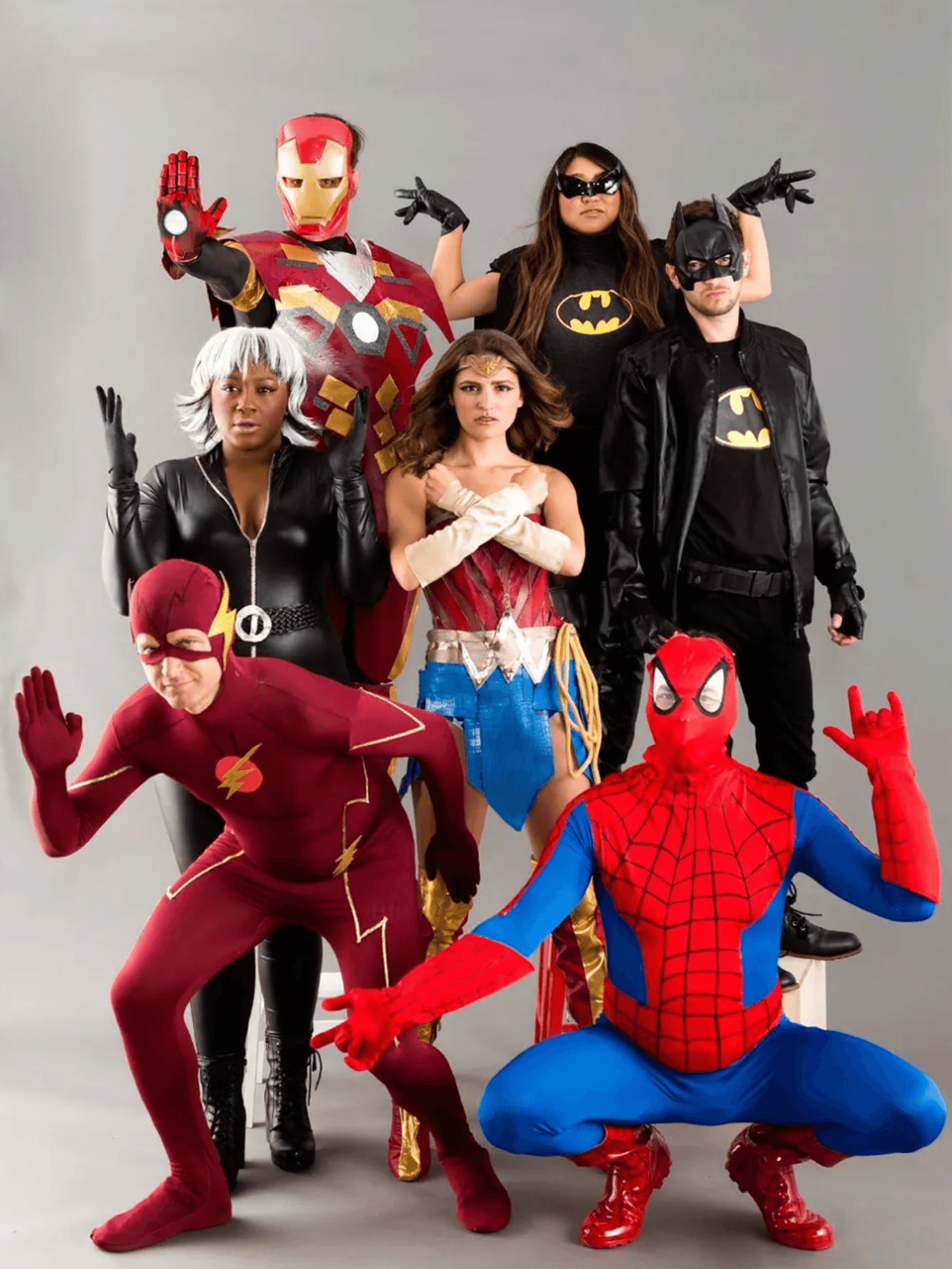 Group of people in superhero costumes posing together.