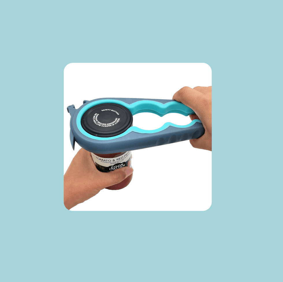 Hands using a blue jar opener on a jar with a black lid.