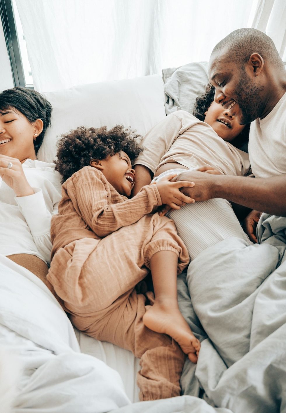 happy family lying in bed