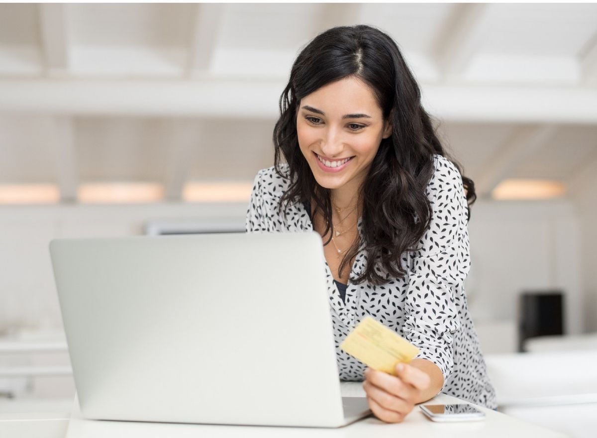 Happy woman shopping on laptop
