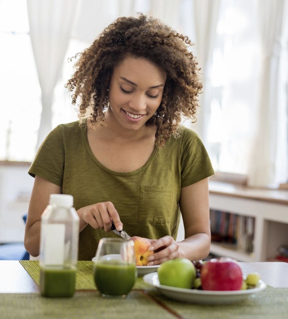 Healthy woman eating fruits for breakfast