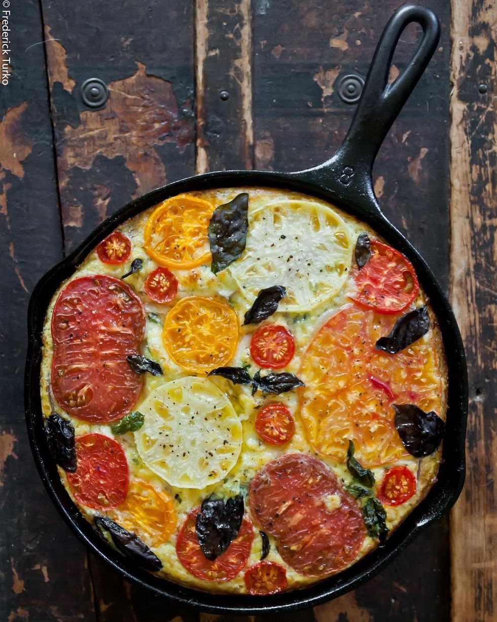 Heirloom Tomato and Basil Frittata in a black skillet