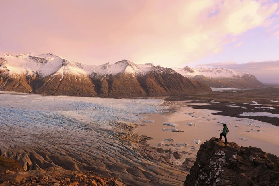 Hiker-on-Top-of-the-Mountain-Overlooking-Skaftafell-Glacier-Iceland-000080139583_Large