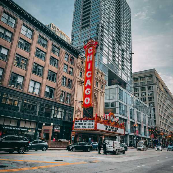 Historic Chicago Theater with vibrant marquee on an urban street.