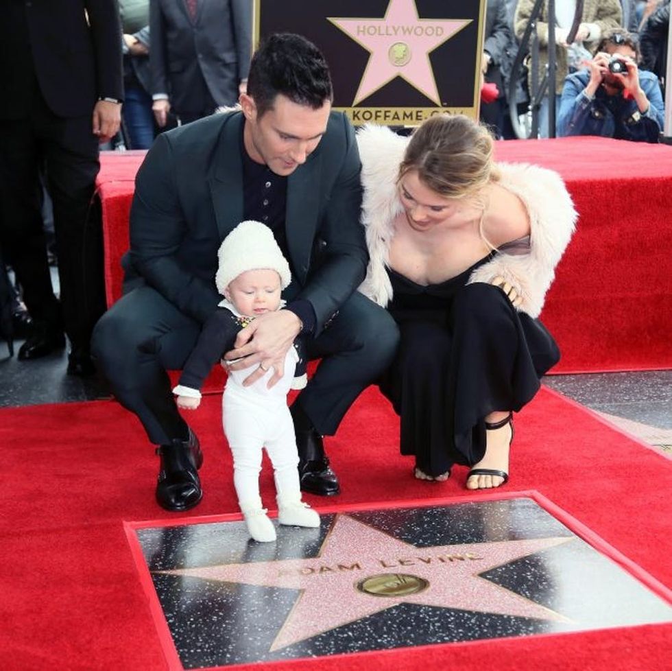 HOLLYWOOD, CA - FEBRUARY 10: Recording artist Adam Levine (L), wife model Behati Prinsloo and their daughter attend his being honored with a Star on the Hollywood Walk of Fame on February 10, 2017 in Hollywood, California. (Photo by David Livingston/Getty Images)