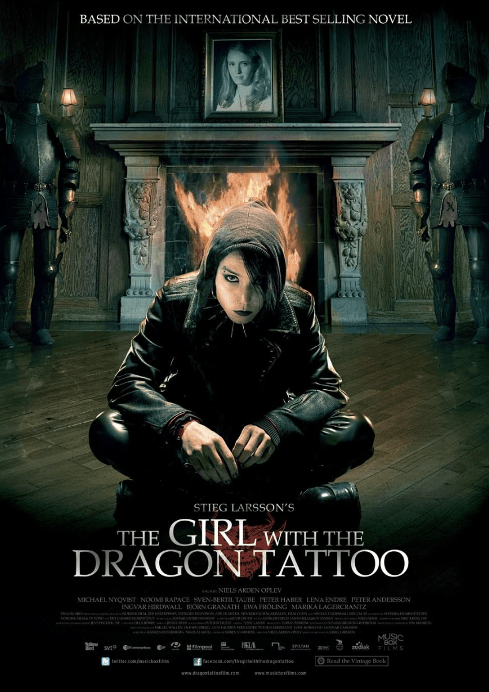 Hooded person crouching by a fireplace with Nordic decor; "The Girl with the Dragon Tattoo."