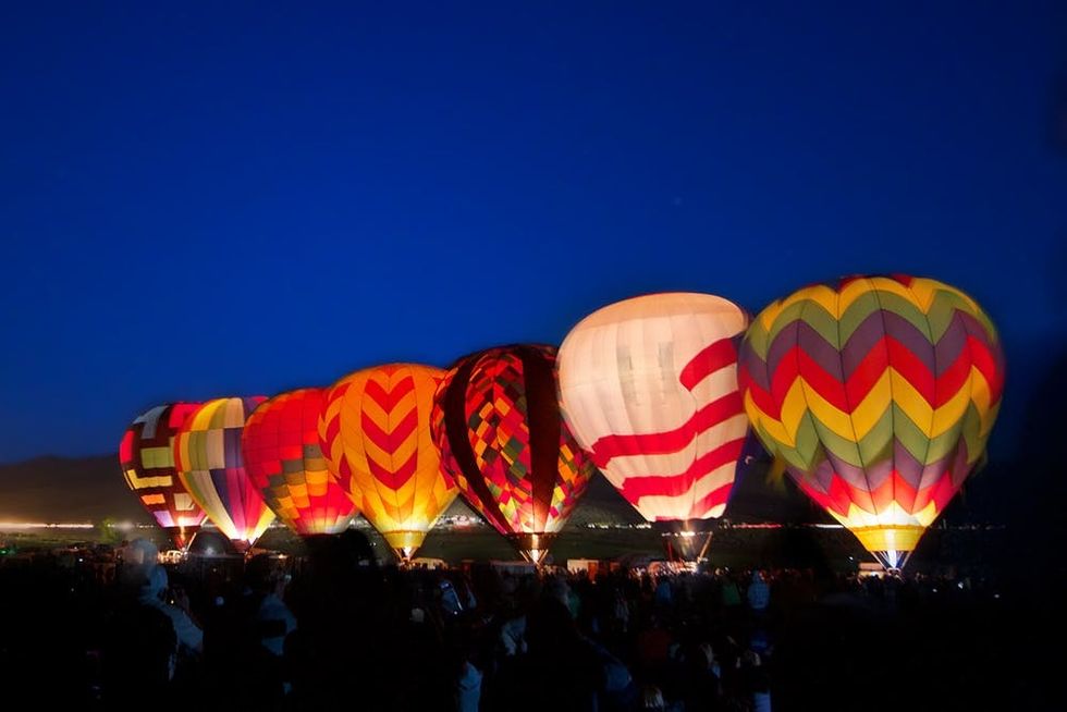 Hot air balloons prepare to take flight just before dawn in Reno