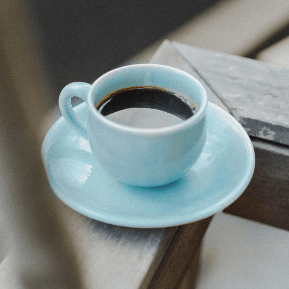Hot brewed coffee served in a light blue mug and saucer