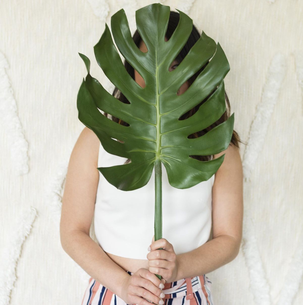 how to deal with childhood trauma woman holding a plant in front of her face