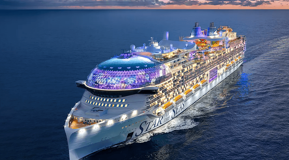 Illuminated cruise ship "Star of the Seas" sailing under a dusk sky.