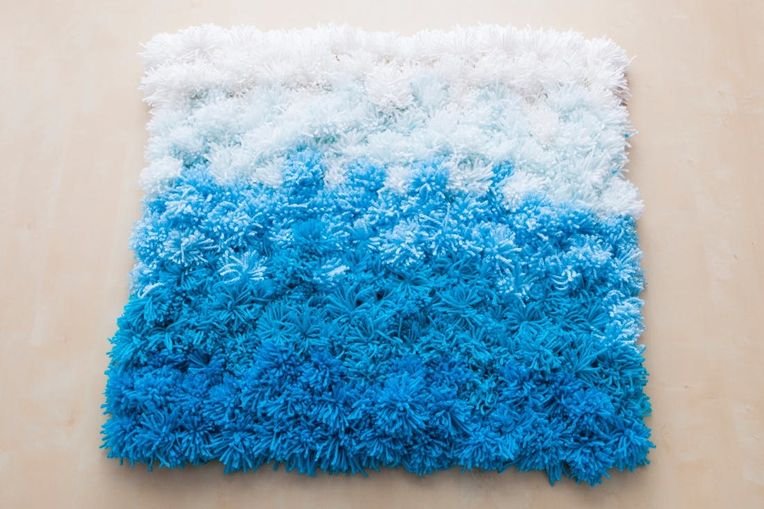 A Pom Pom Rug Wall Hanging And Table Cover In One Brit Co