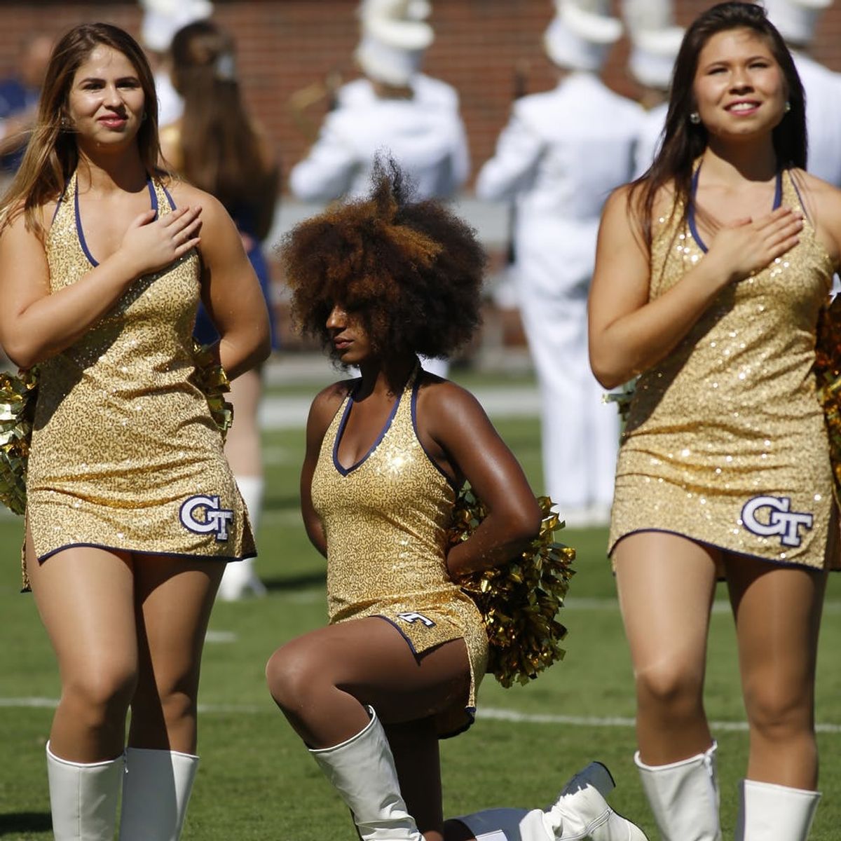 Here’s the Unexpected Story Behind the Viral #TakeAKnee Cheerleader Photo