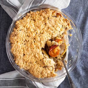 This pie has a spoon lifting up persimmons on a delicious looking crumble on an apple oat pie makes for one of many great persimmon recipes