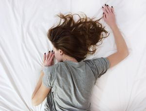 woman sleeping in sheets