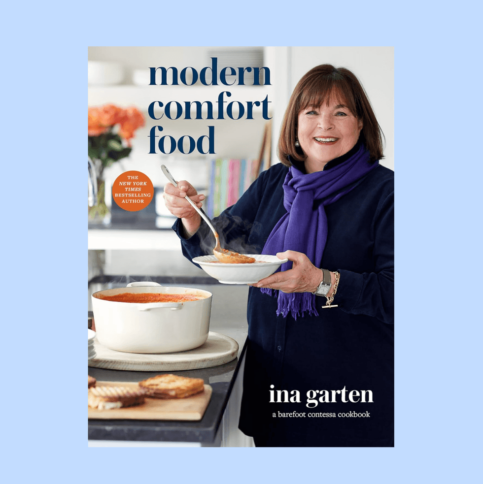 Ina Garten cooking, holding soup, on "Modern Comfort Food" cookbook cover.