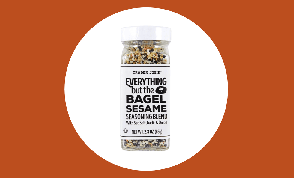 Jar of "Everything but the Bagel" seasoning on white circle, brown background.