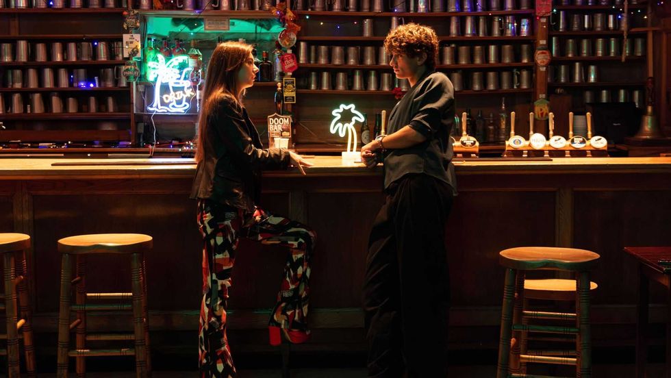 Jennifer James and Gavin Casalegno at a bar in Sunflower Child