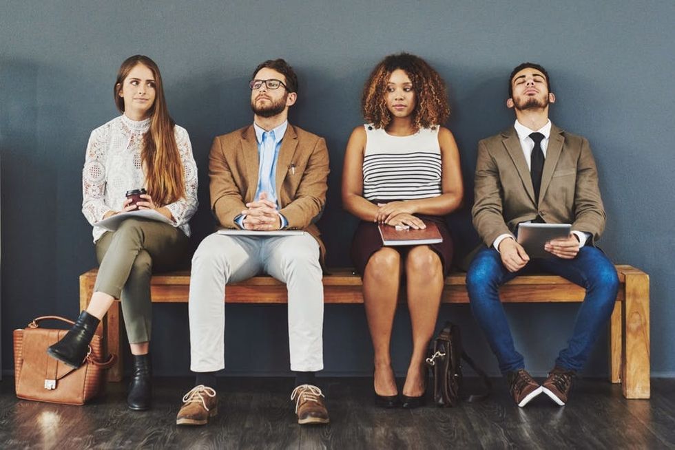 Job applicants sit together as they await their interviews