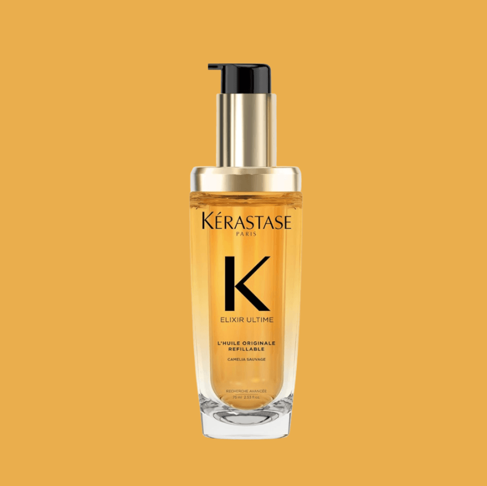 K\u00e9rastase Elixir Ultime hair oil bottle with pump on a solid orange background.