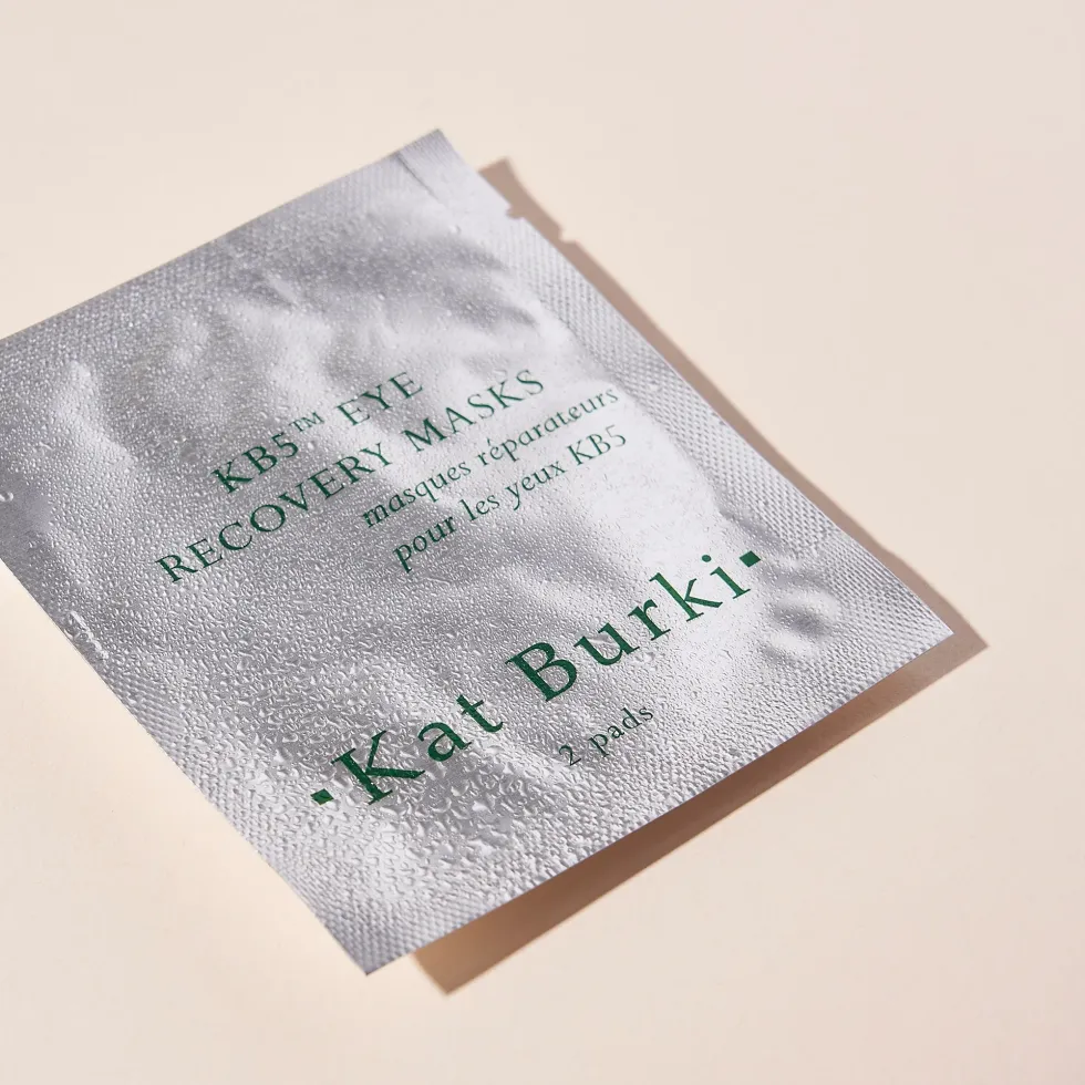 Kat Burki Eye Recovery Masks packaging is shown against a light orange background.