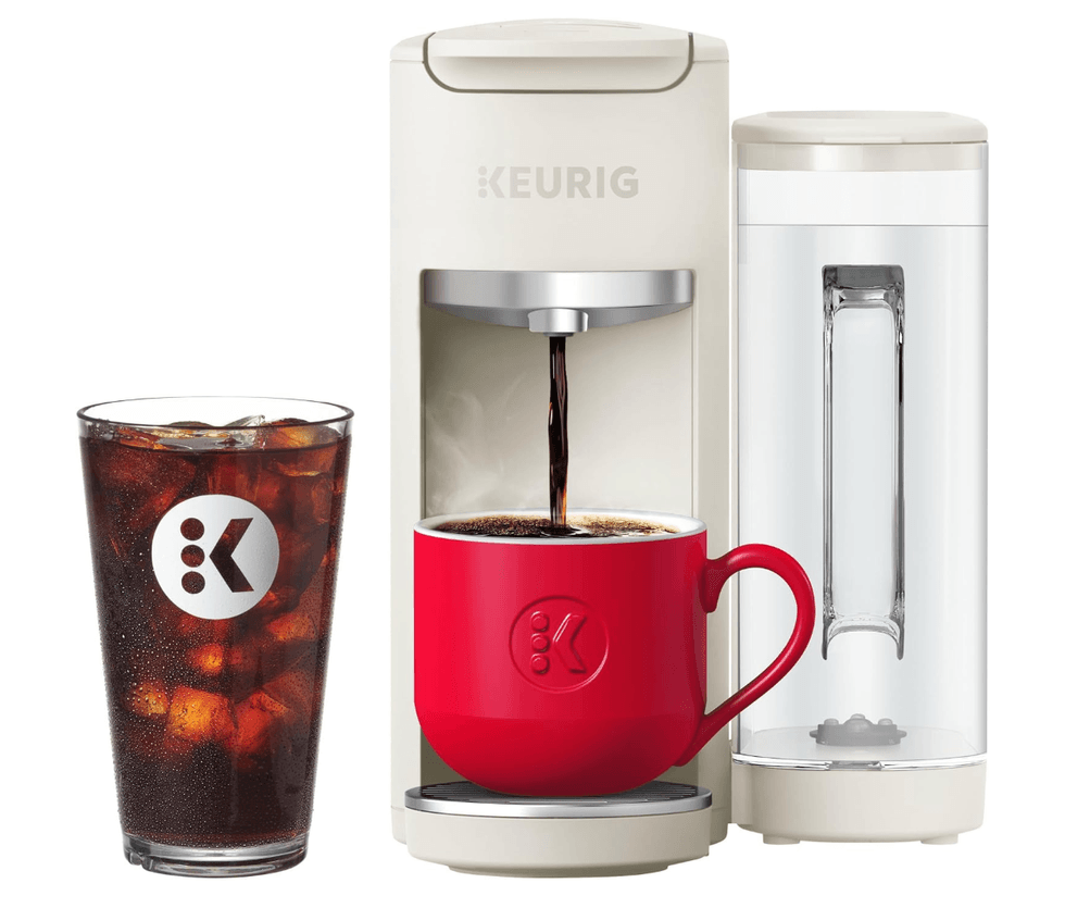Keurig coffee maker with red mug and iced coffee glass beside it.