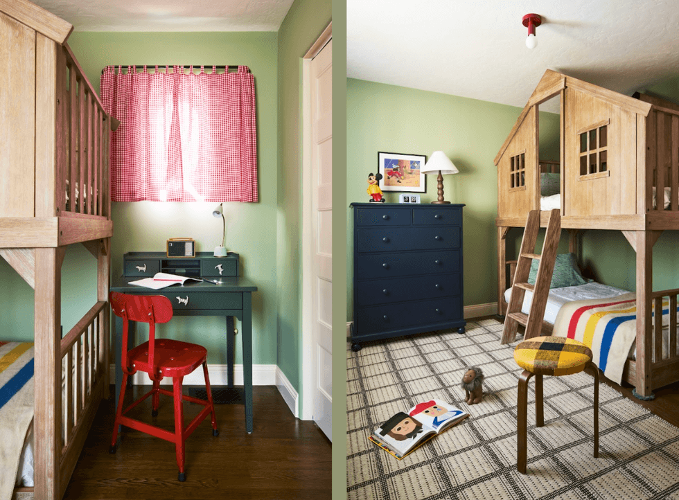 Kids' room with bunk bed, play area, red chair, and green walls.