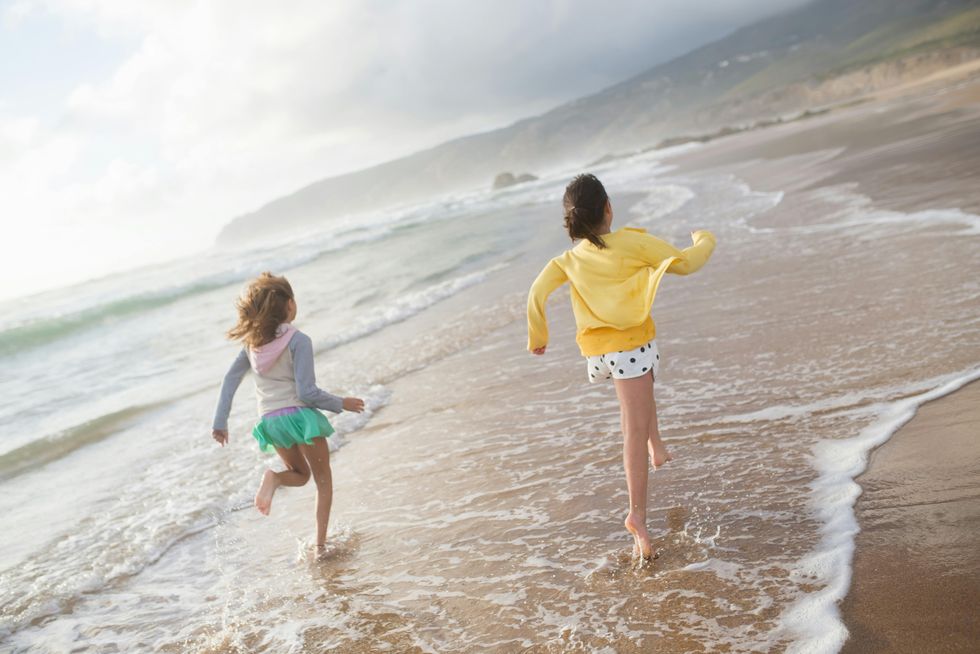 kids running on the beach