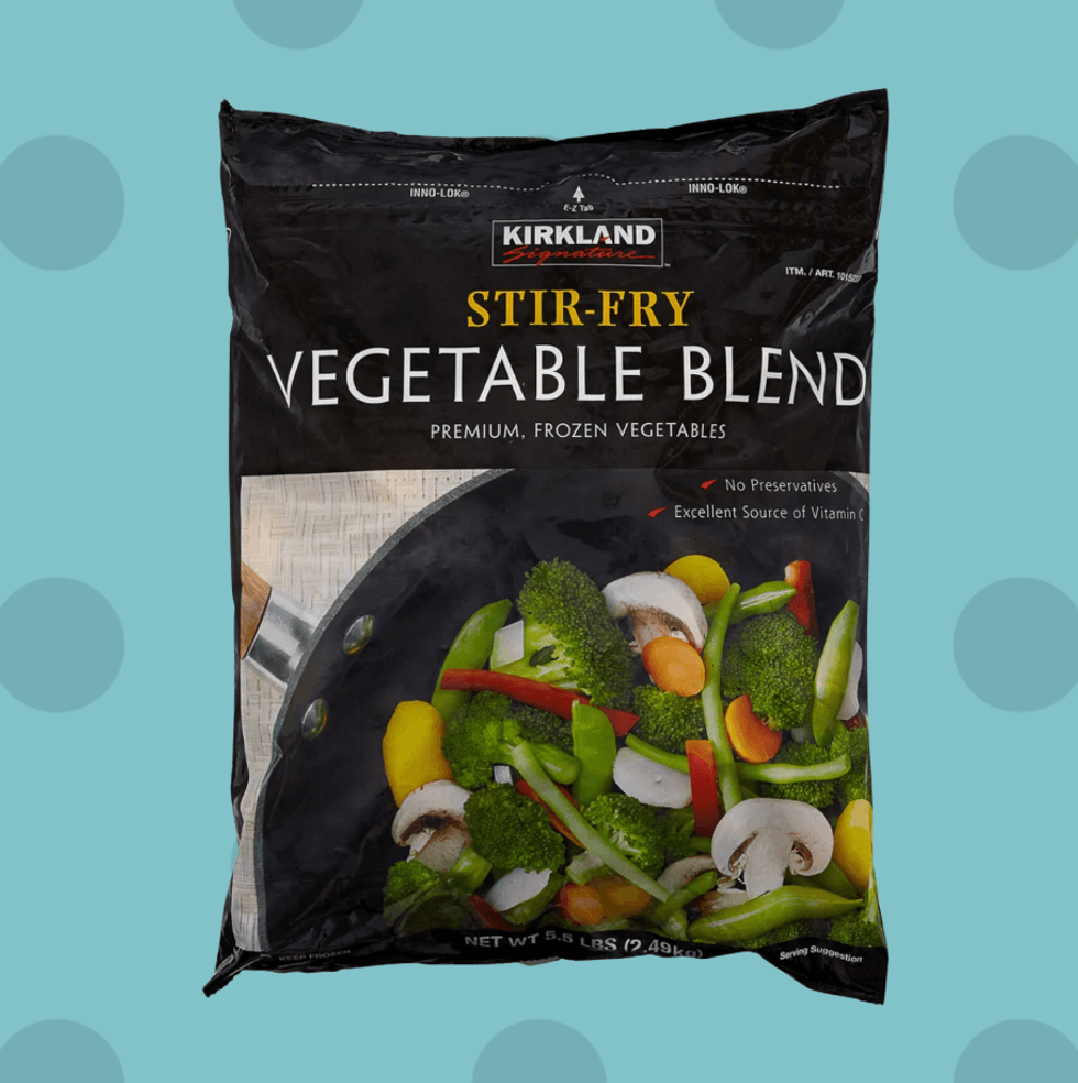 Kirkland Signature Stir-Fry Vegetable Blend, frozen, on a blue dotted background.