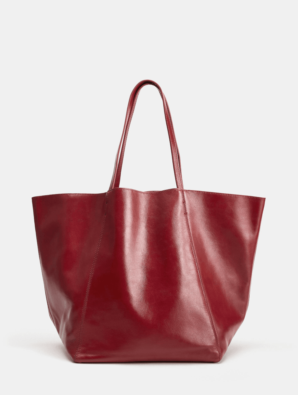 Large red leather tote bag with thin handles.