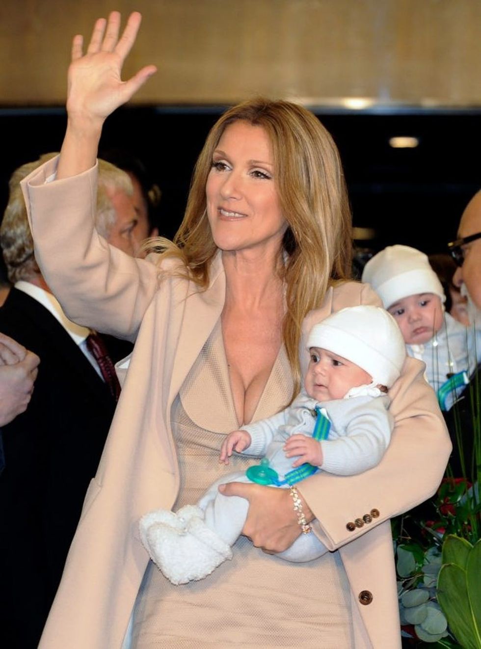 LAS VEGAS, NV - FEBRUARY 16: Singer Celine Dion waves as she holds her son Nelson Angelil, with his twin Eddy Angelil in the background, as she arrives at Caesars Palace February 16, 2011 in Las Vegas, Nevada. Dion will begin rehearsals for her new show set to debut March 15 at The Colosseum at Caesars Palace. (Photo by Ethan Miller/Getty Images)