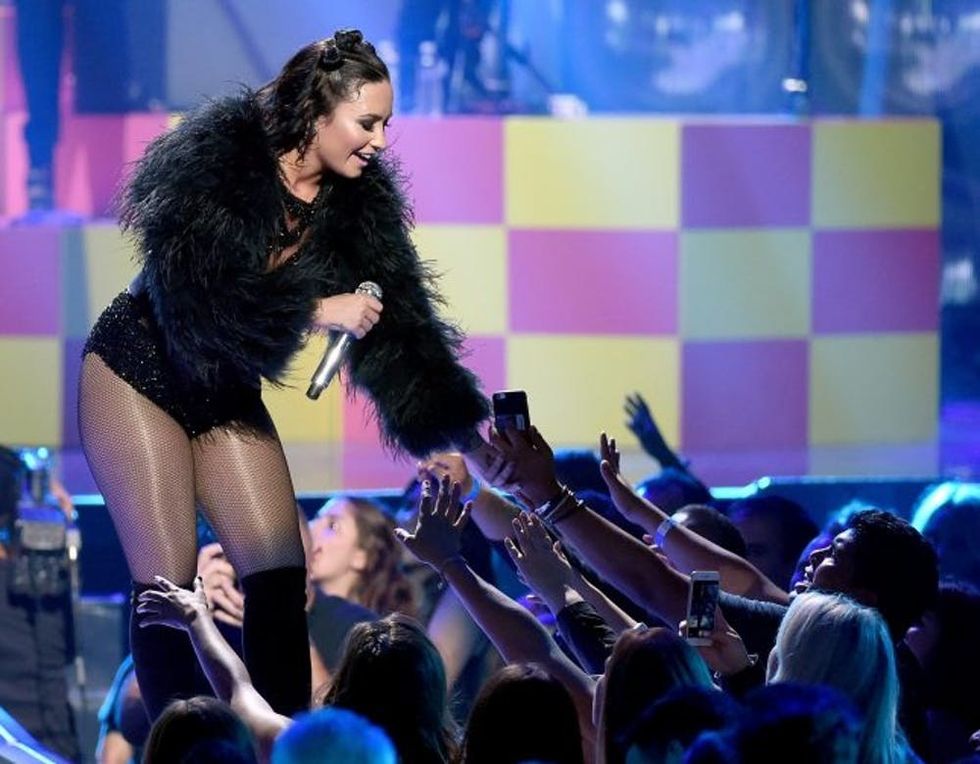 LAS VEGAS, NV - SEPTEMBER 18: Singer/songwriter and actress Demi Lovato reaches out to fans as she performs at the 2015 iHeartRadio Music Festival at MGM Grand Garden Arena on September 18, 2015 in Las Vegas, Nevada. (Photo by Ethan Miller/Getty Images for iHeartMedia)