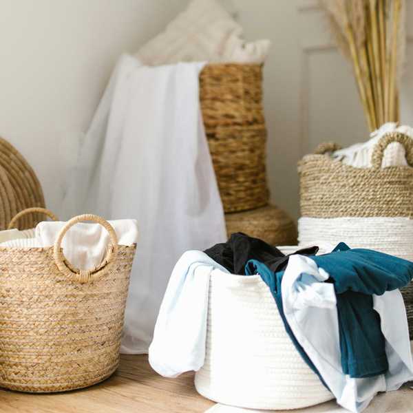 Laundry baskets with clothes in a bright, cozy room.