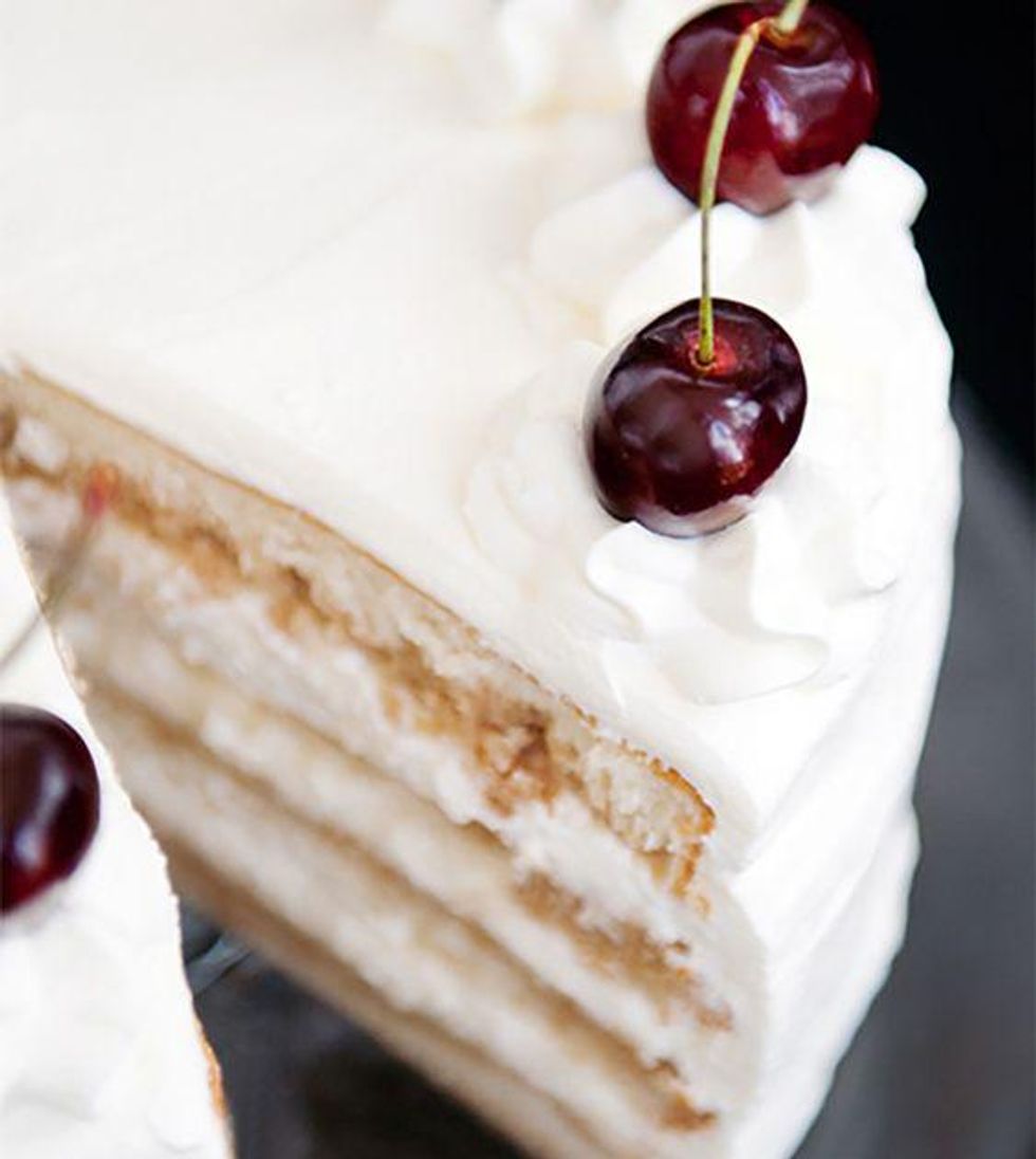 layered white russian cake with cherry on top