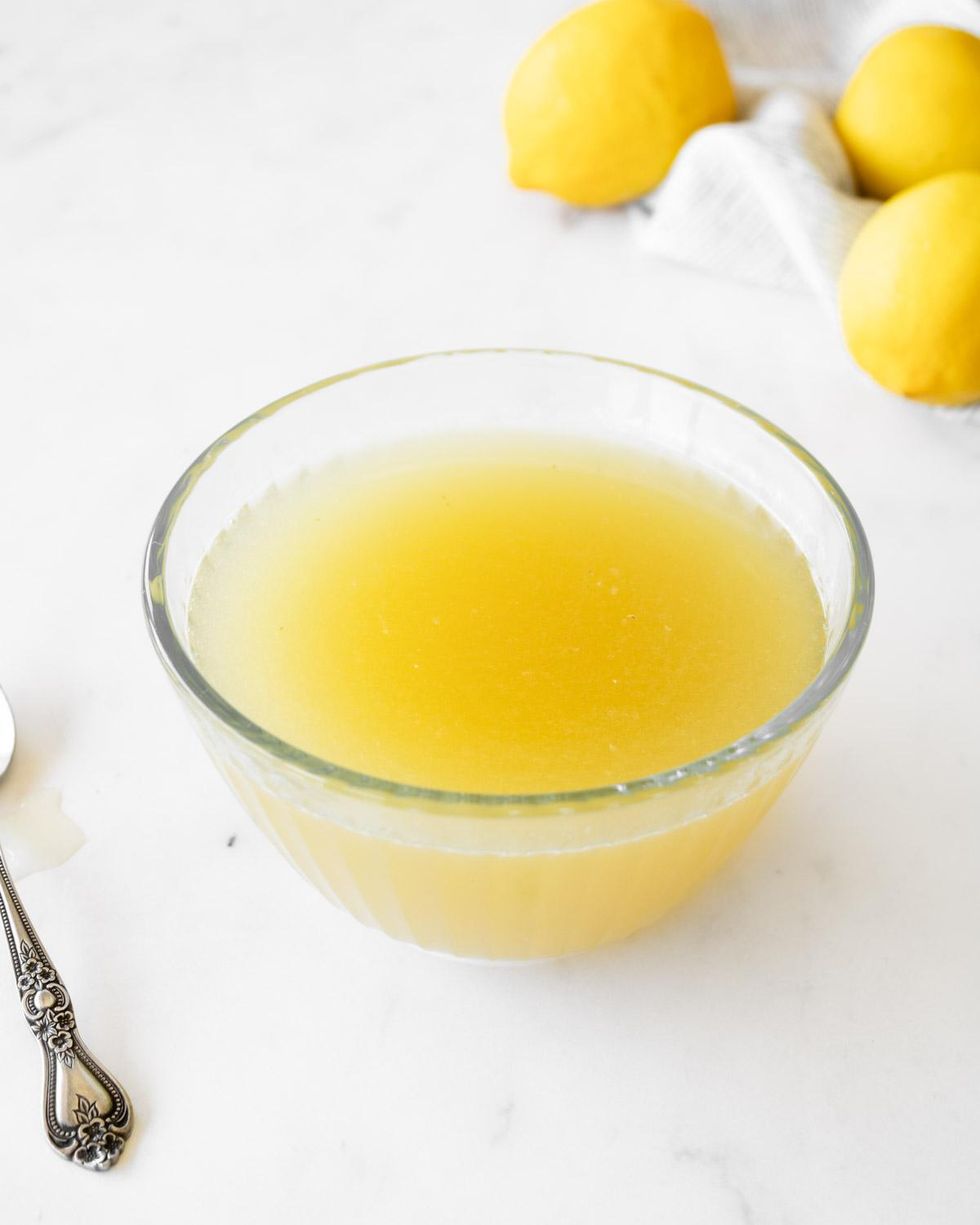 Lemon syrup is shown in a small glass bowl