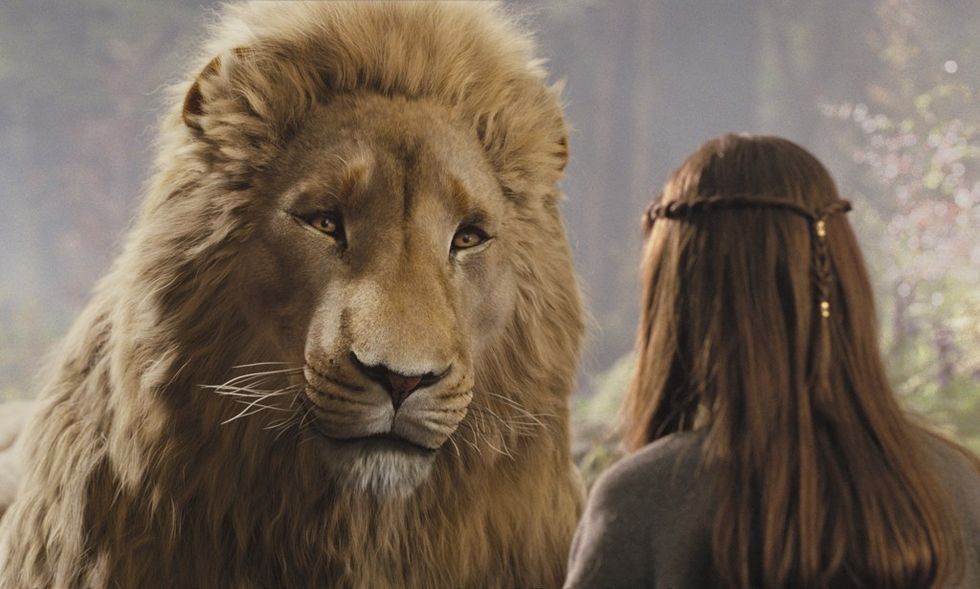 Liam Neeson as the voice of Aslan and Georgie Henley in The Chronicles of Narnia
