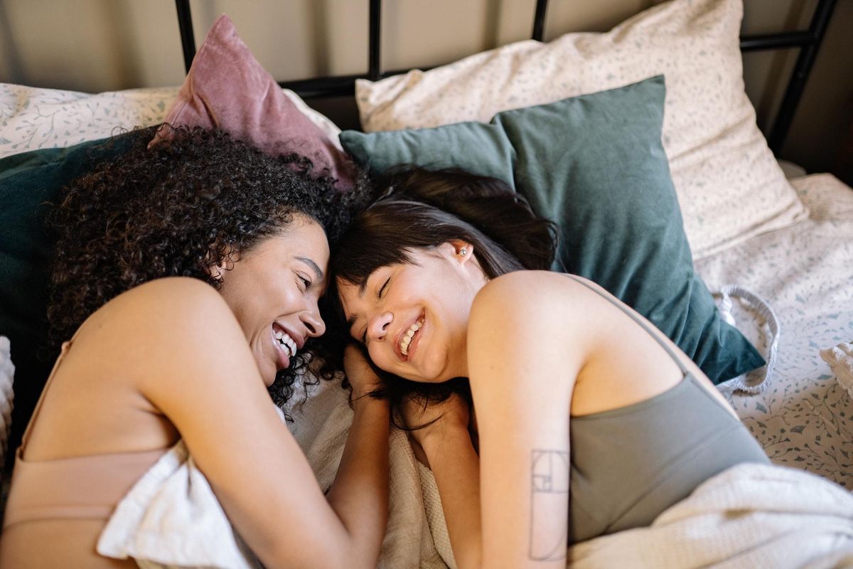 libra compatibility women laughing together in bed
