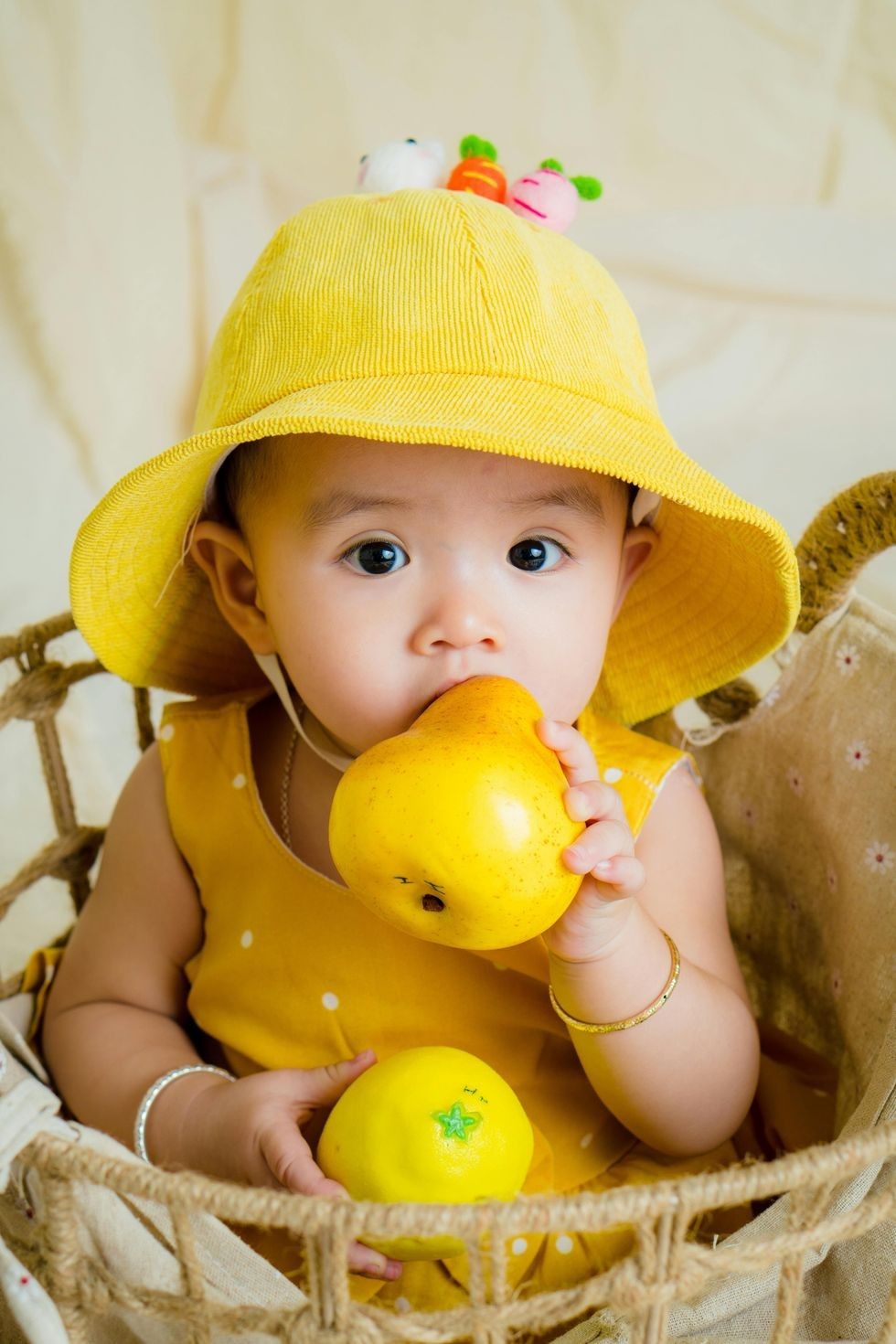 little baby holding a lemon