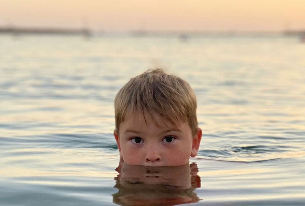 little boy in the ocean