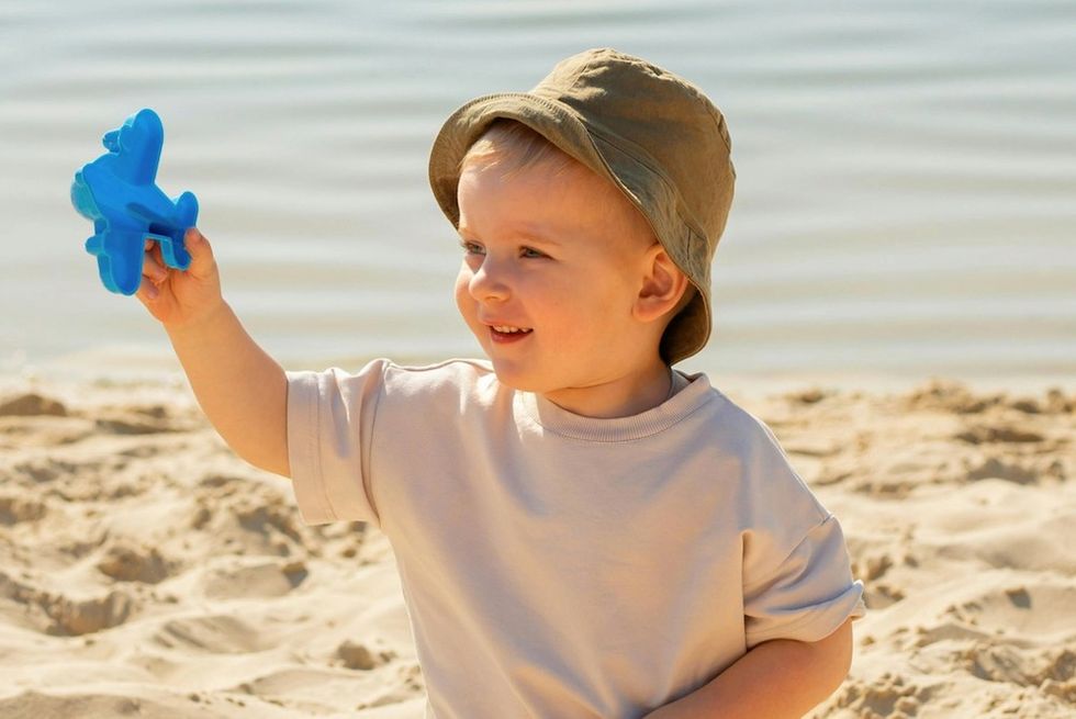 little boy playing in the sand