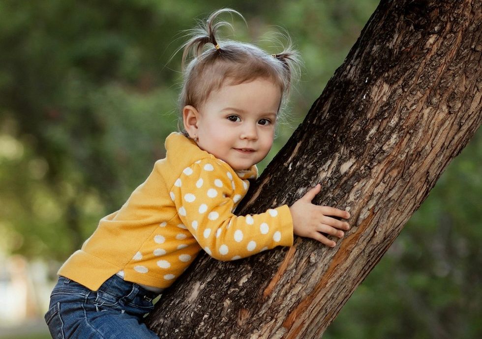 little girl climbing a tree