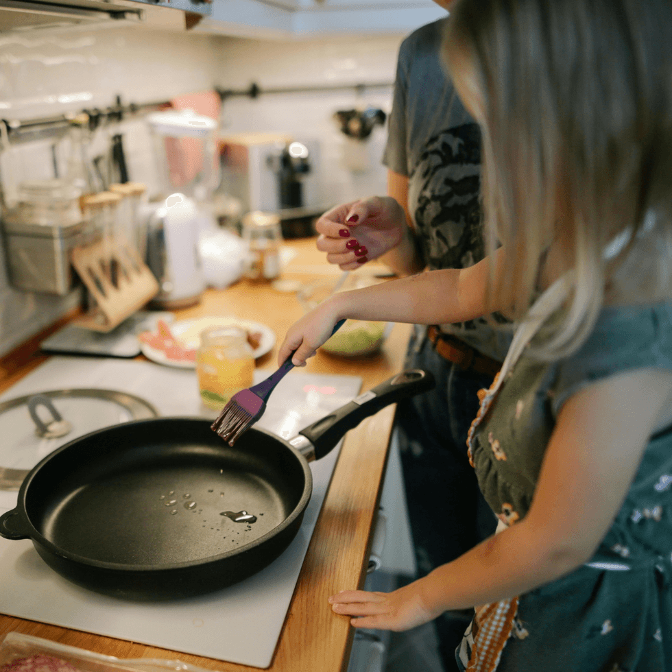 Little girl cooking in skillet