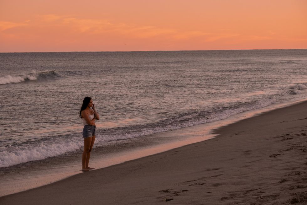 lola tung standing on the beach at wilmington north carolina
